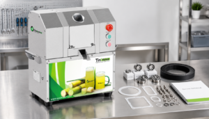 Commercial sugarcane juice machine with organised maintenance spare parts on a workbench